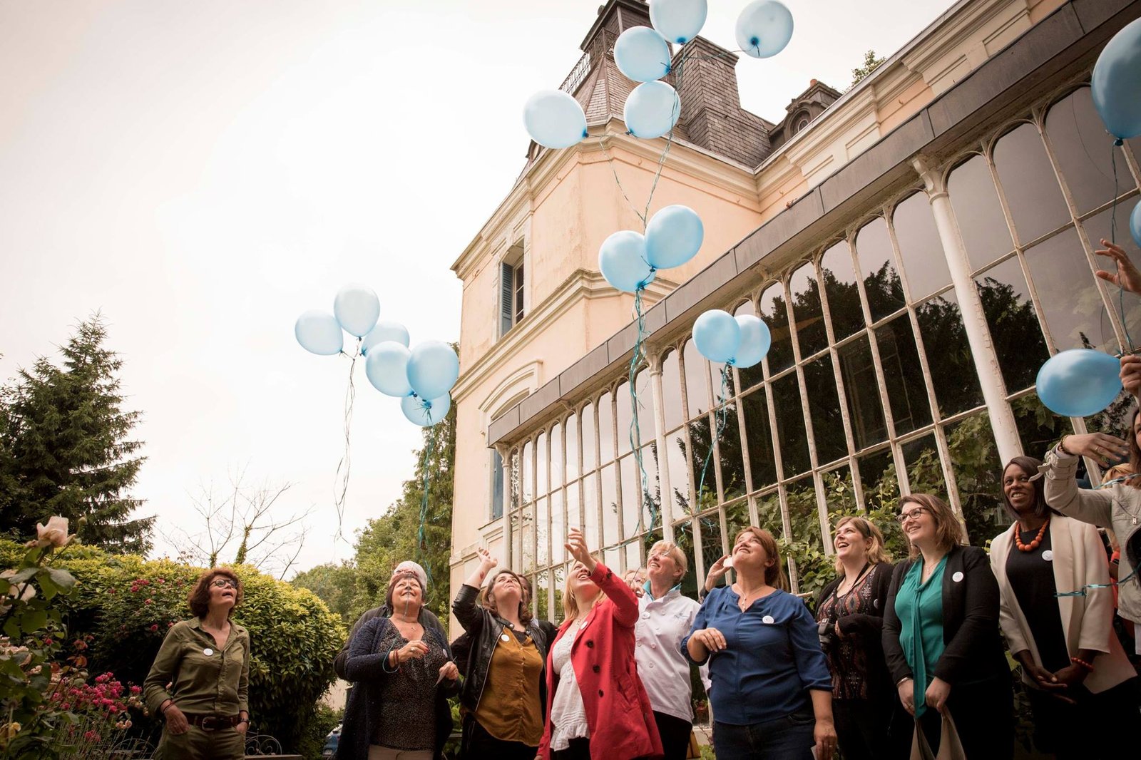 Événement avec lâcher de ballons devant une orangerie